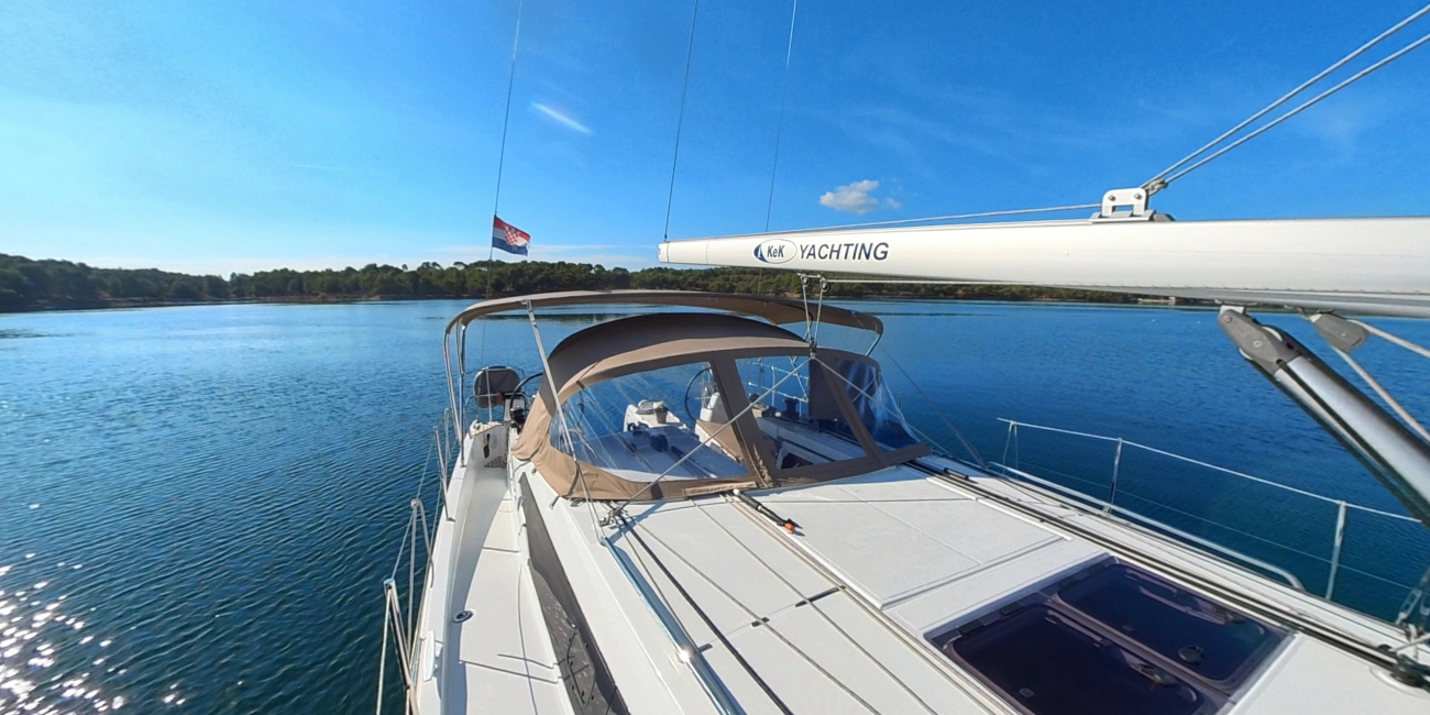 Open deck and cockpit of a KEK Yachting sailboat at anchor